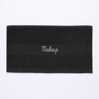 Premium Turkish black makeup towel for hotels, horizontal view showing embroidered band, ideal for guest rooms and spas.