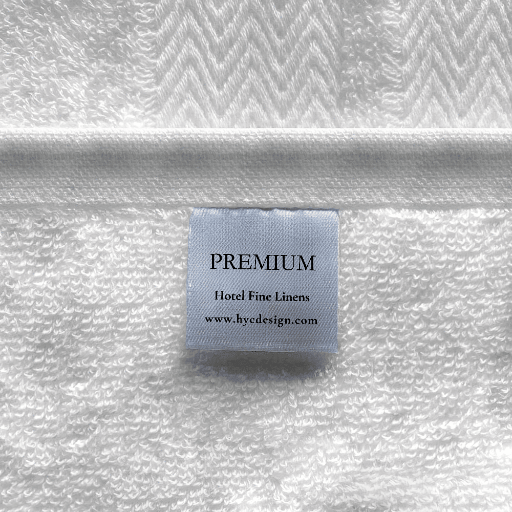 Close-up of a combed cotton bath sheet showcasing a dense, plush weave and a refined decorative border
