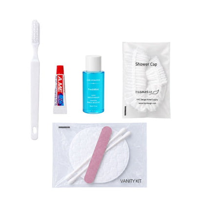 Travel amenity set with toothbrush, toothpaste, mint mouthwash, shower cap and vanity kit for convenient personal care.