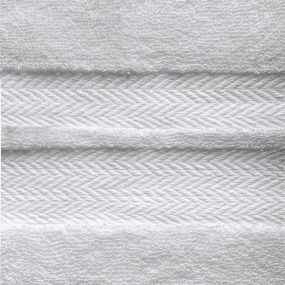 Close-up of a combed cotton bath sheet showcasing a dense, plush weave and a refined decorative border