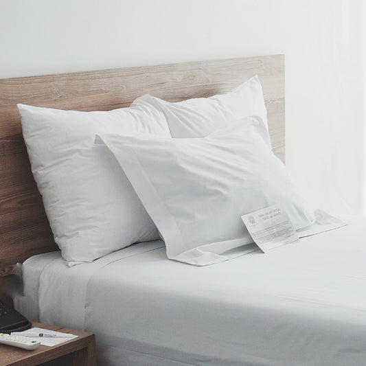 Hotel Bed with Pillows inside Pillowcase