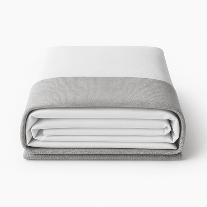 Folded light gray and white bed hugger for hotel rooms, modern and elegant hospitality bedding.