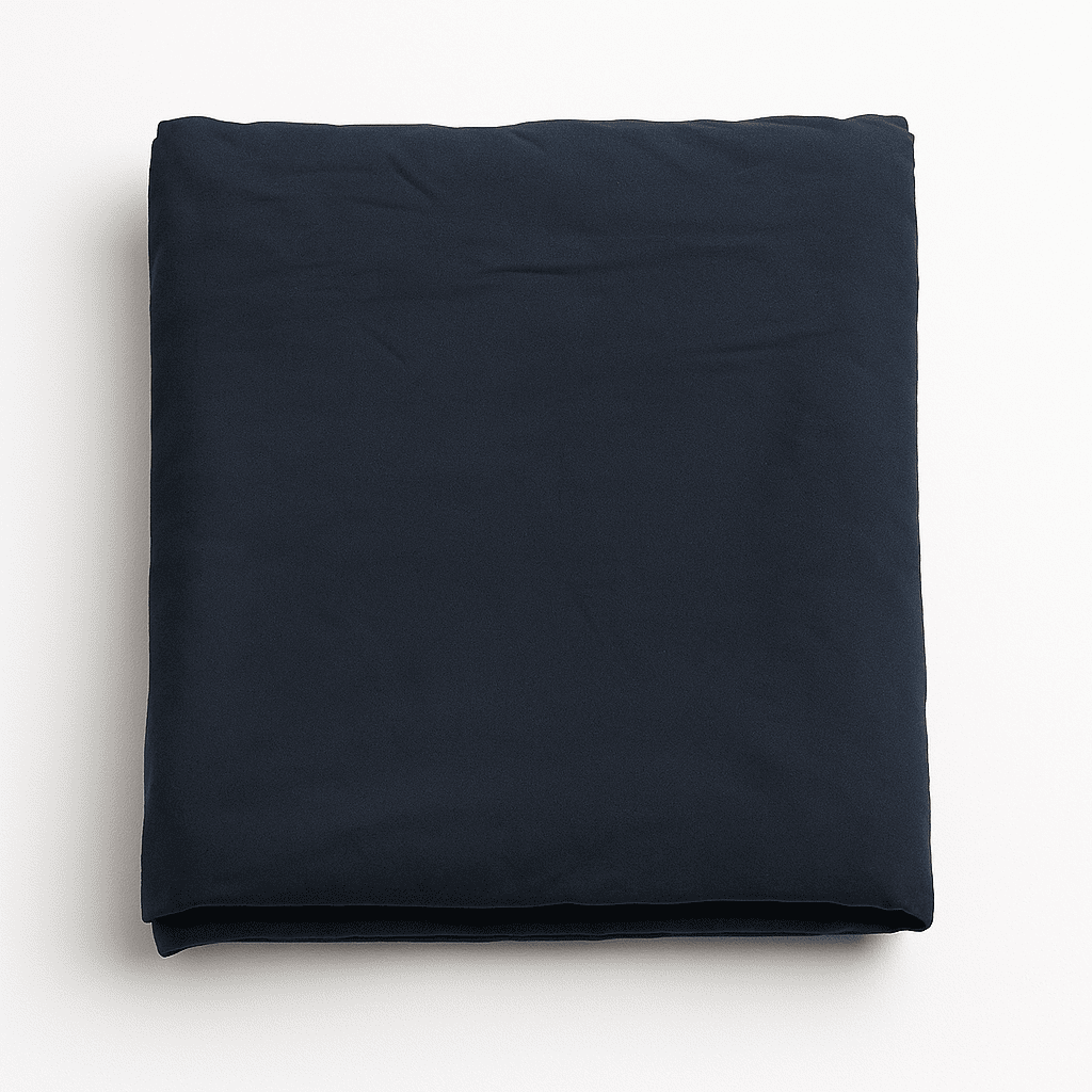 Navy blue bed sheet neatly folded on white background, smooth cotton fabric ideal for hotels, resorts, and Airbnb stays.