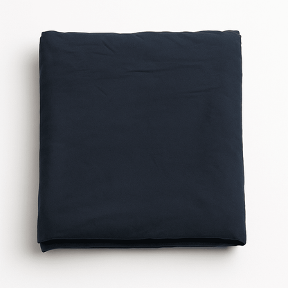 Navy blue bed sheet neatly folded on white background, smooth cotton fabric ideal for hotels, resorts, and Airbnb stays.
