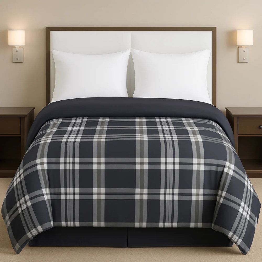 Grey plaid comforter styled on a neatly made bed with crisp white pillows for a classic, modern bedroom look.