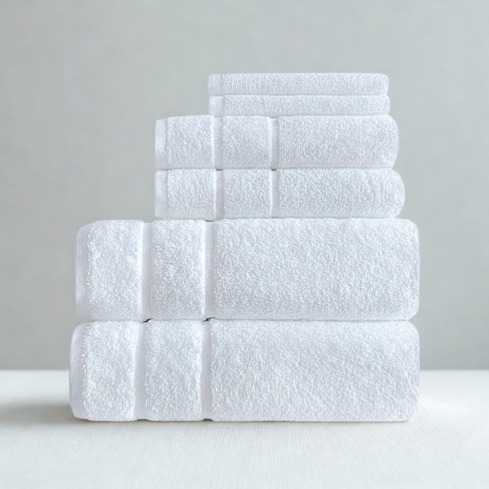 Absorbent hotel-style towel set in white, including bath and hand towels for luxury bathroom use.