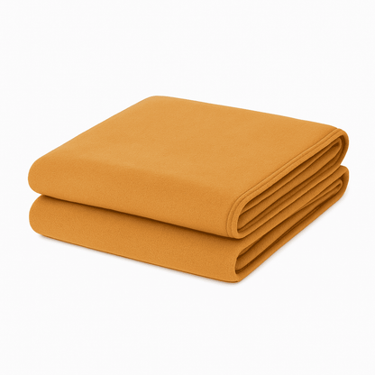 Yellow ocher blanket folded neatly on white background, soft lightweight throw ideal for hotels, resorts, and Airbnb stays.