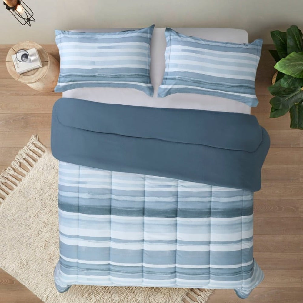 A room with a bed that has a printed "Water Stripe Duvet Cover 3 Piece set Temperature-controlled queen-size comforter offering hypoallergenic properties and essential warmth, perfect for upscale Airbnb rentals
