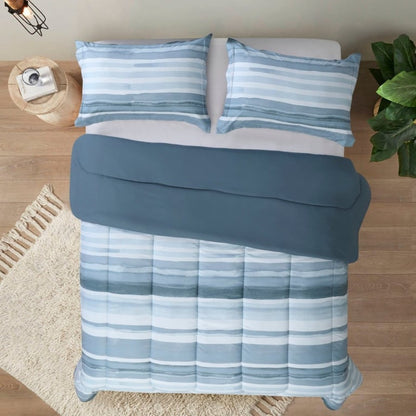 A room with a bed that has a printed "Water Stripe Duvet Cover 3 Piece set Temperature-controlled queen-size comforter offering hypoallergenic properties and essential warmth, perfect for upscale Airbnb rentals